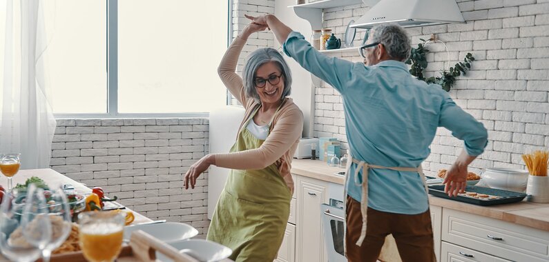 Elderly couple dancing in the kitchen